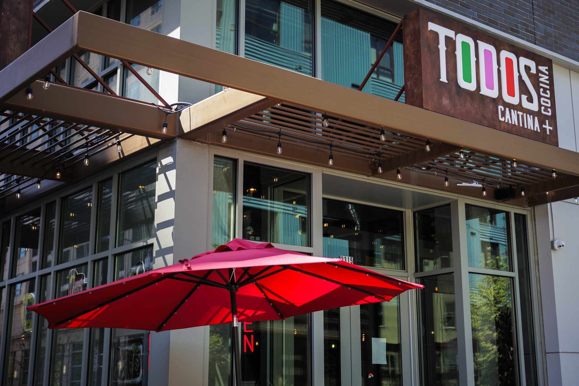 Exterior of of a downtown restaurant. The sign reads, "Todos Cantina + Cocina."