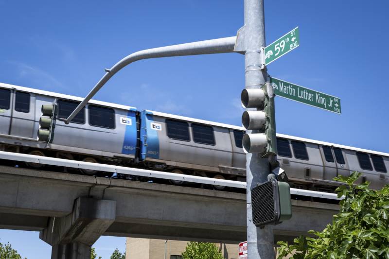 A BART train above two streets intersecting