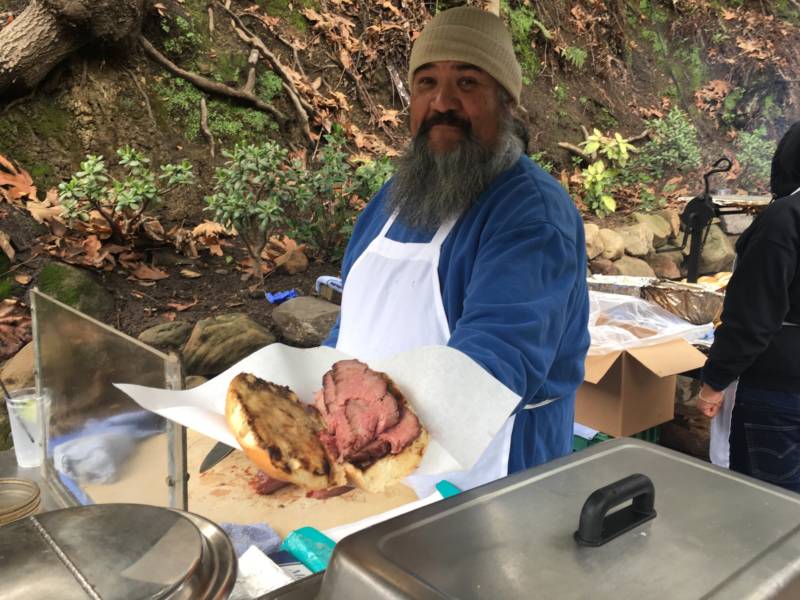 Barbecue chef Tom Perez proudly displays his tri-tip sandwich.