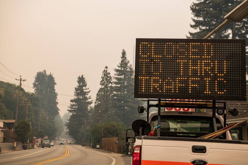 Digital sign in truck bed says "Road Closed to Through Traffic"